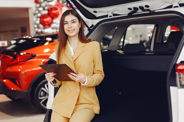 Stylish and elegant woman in a car salon