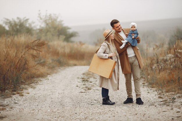 Stylish family walking on a autumn field