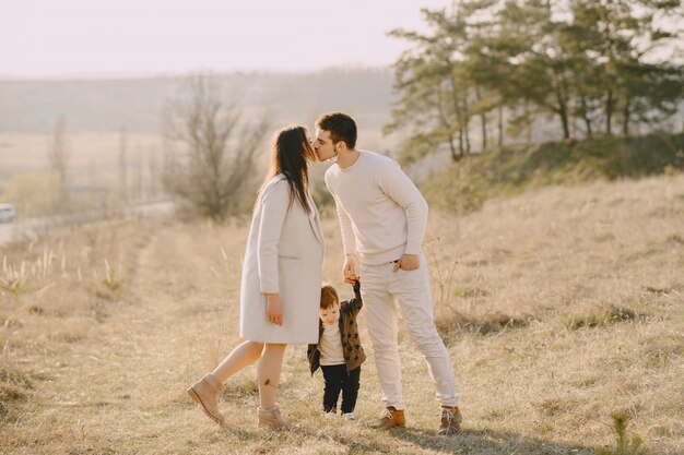 Stylish family walking on a sunny field