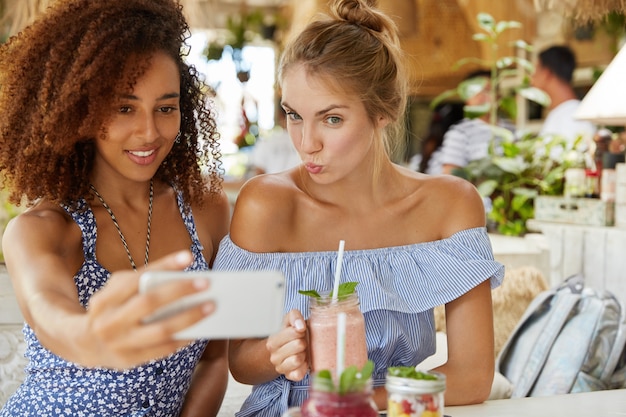 Stylish friends sitting in cafe