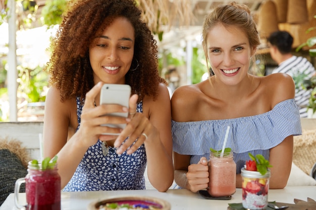 Stylish friends sitting in cafe