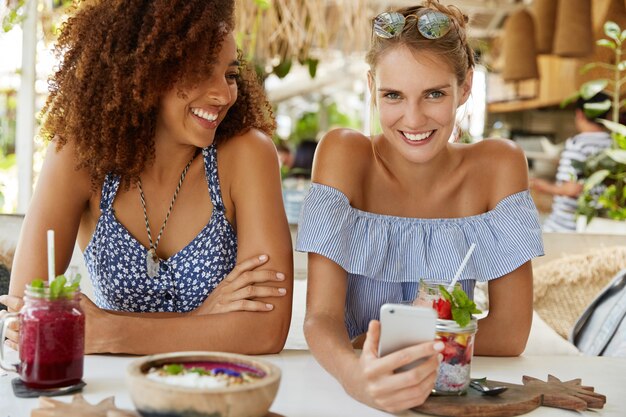 Stylish friends sitting in cafe