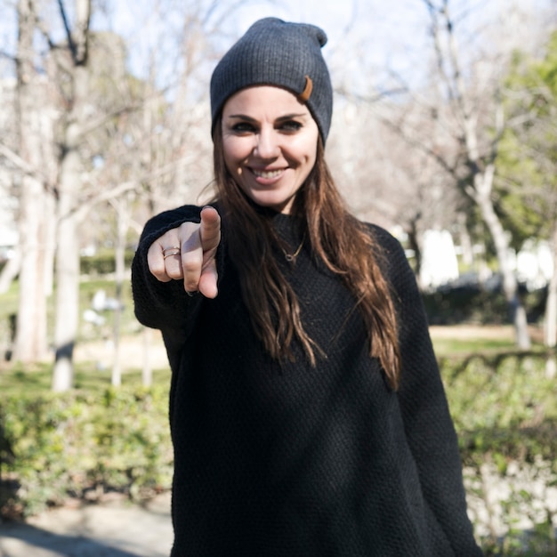 Stylish girl pointing at camera