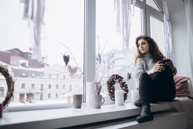 Free Photo the stylish girl sitting on the window-sill