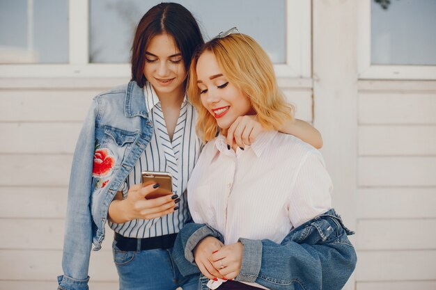 stylish girls standing in a city