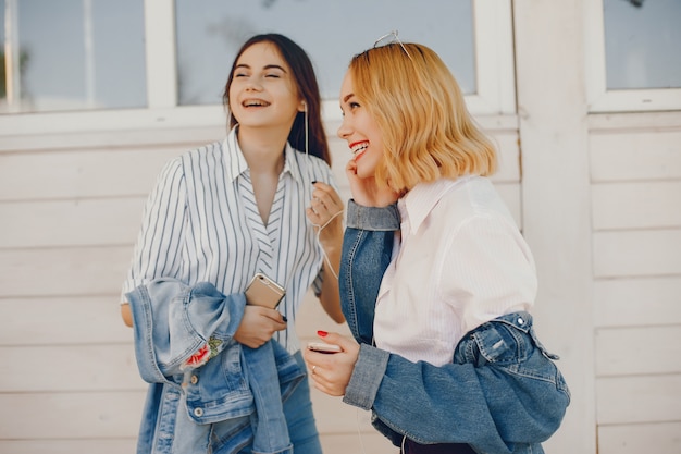 stylish girls standing in a city