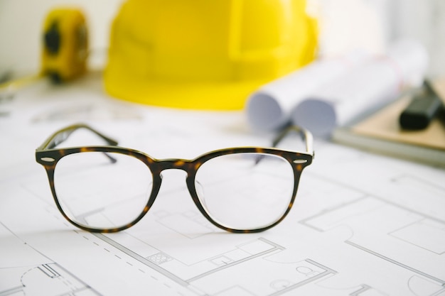 Stylish glasses on blueprints