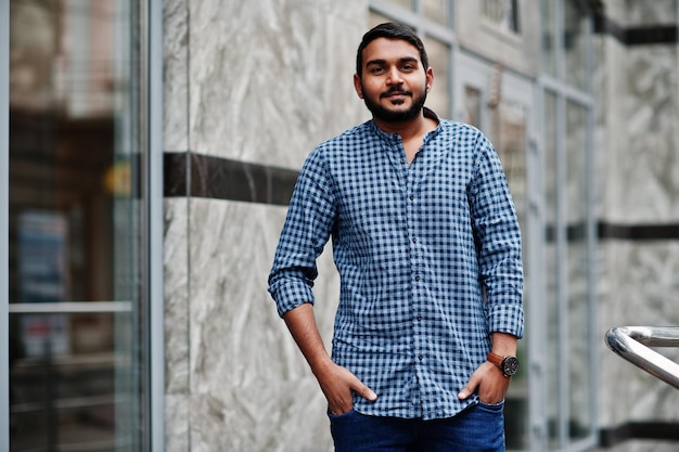 Stylish indian beard model man in casual clothes posed outdoor at street of India