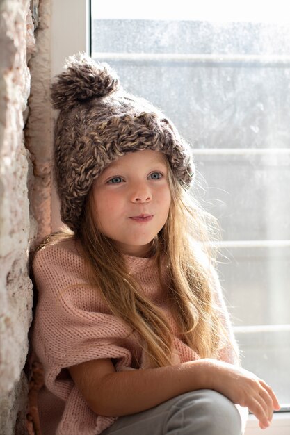 Stylish little girl posing with winter hat