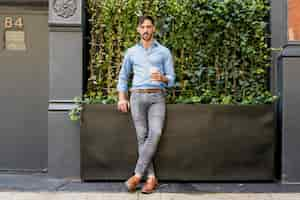 Free photo stylish male model drinking coffee