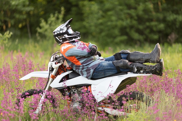 Free photo stylish man relaxing on top of motorbike