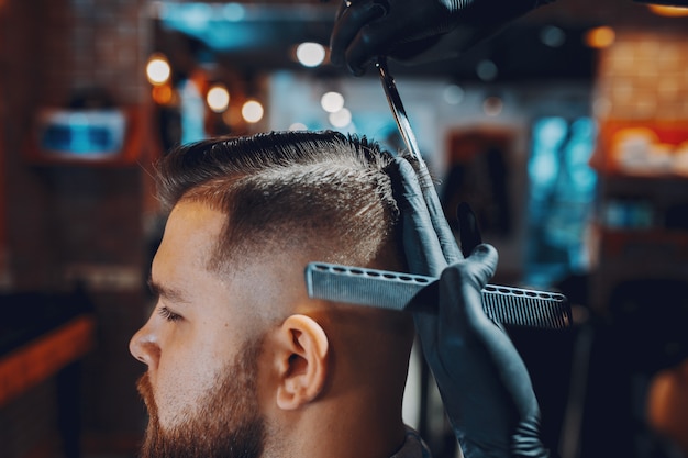 Stylish man sitting in a barbershop