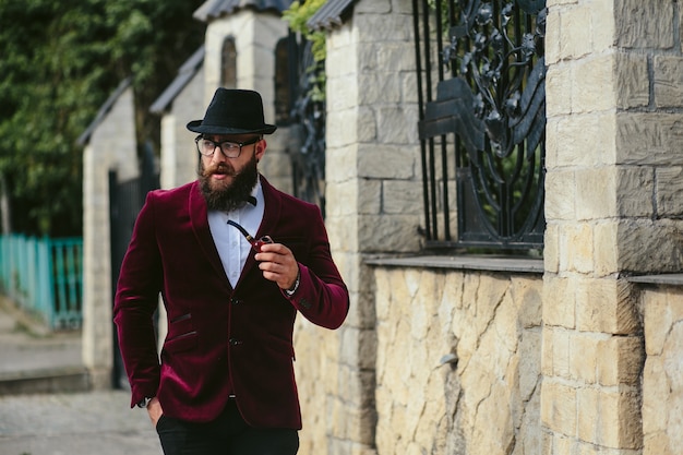 Free Photo stylish man smoking while walking