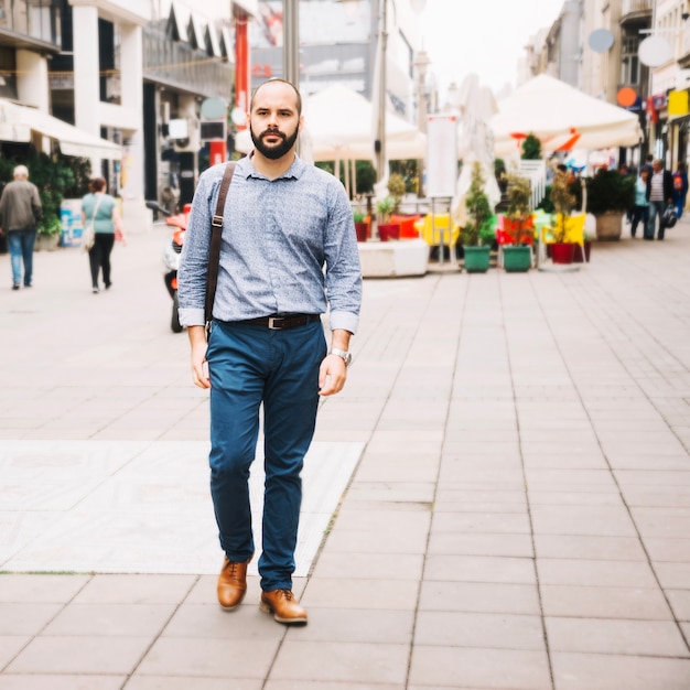 Free Photo stylish man walking down street