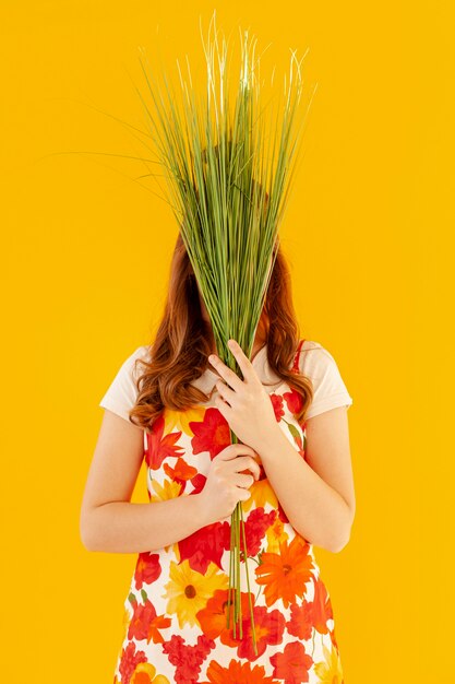 Stylish model holding plants front view