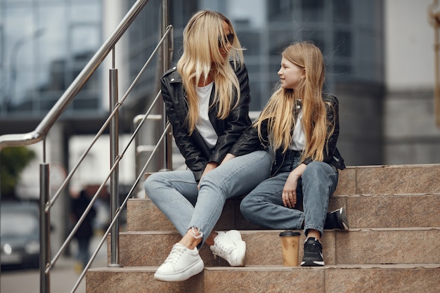 Stylish mother with daughter in a summer city