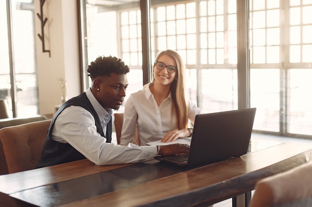 Stylish people working in a office and use the laptop