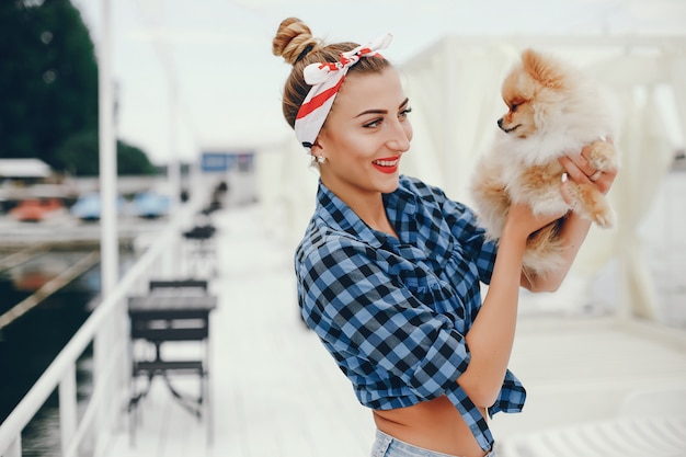 Free photo stylish pin up girl with the little dog