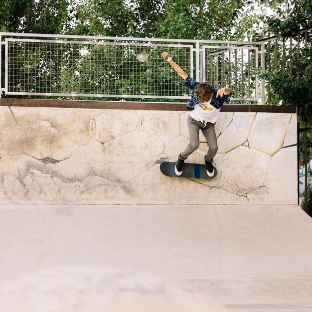 Stylish skater boy in half pipe