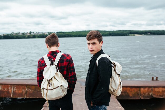 Stylish teens with backpacks posing