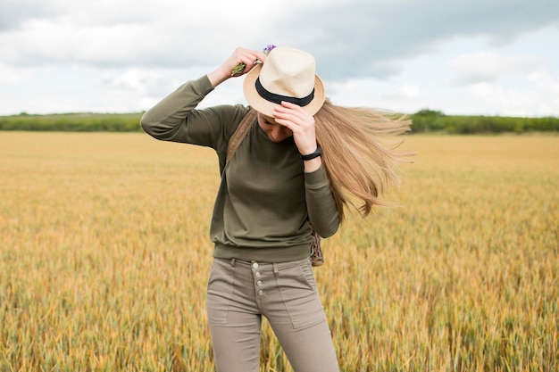 Free photo stylish traveller arranging holiday hat