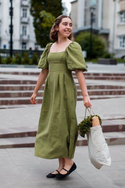 Free photo stylish woman carrying organic groceries