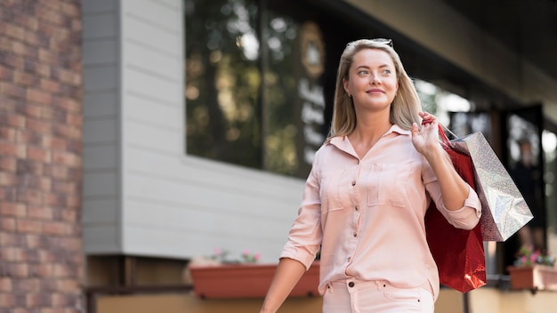 Stylish woman carrying shopping bags