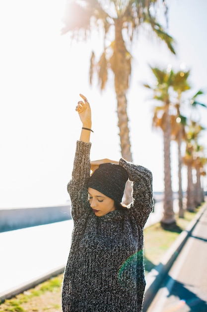 Stylish woman in front of palm trees