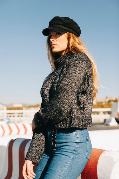 Free Photo stylish woman leaning against barrier