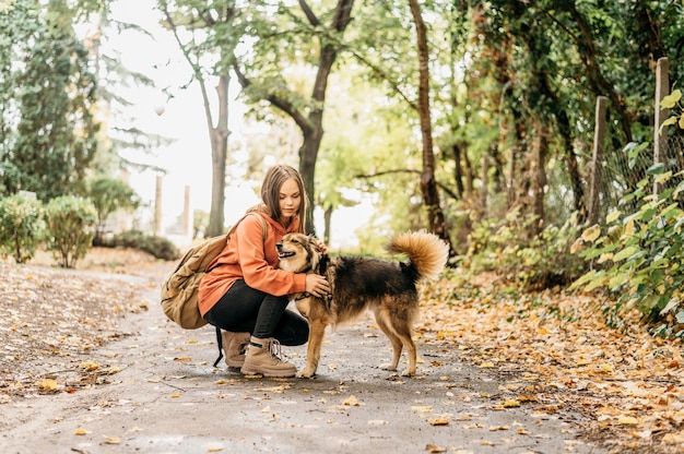 Stylish woman out for a walk with her dog