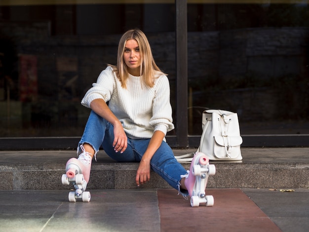 Free photo stylish woman posing with roller skates