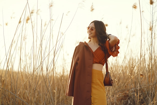 Stylish woman spending time in a summer field