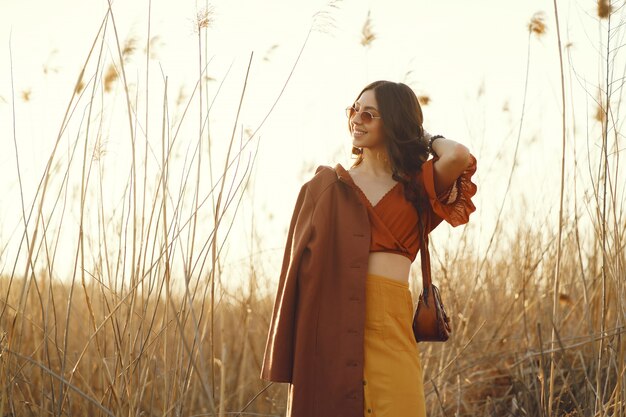 Stylish woman spending time in a summer field