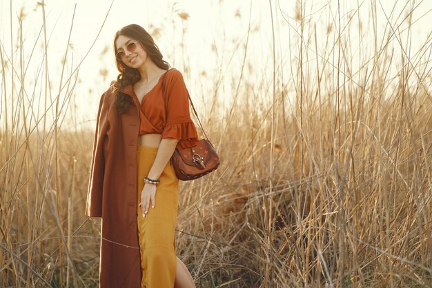 Stylish woman spending time in a summer field