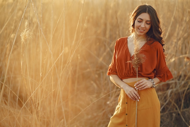 Stylish woman spending time in a summer field