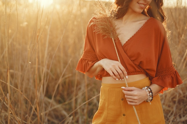 Stylish woman spending time in a summer field