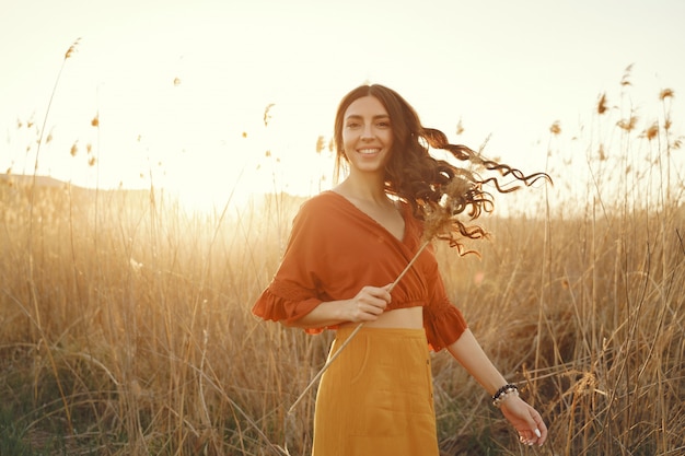 Stylish woman spending time in a summer field