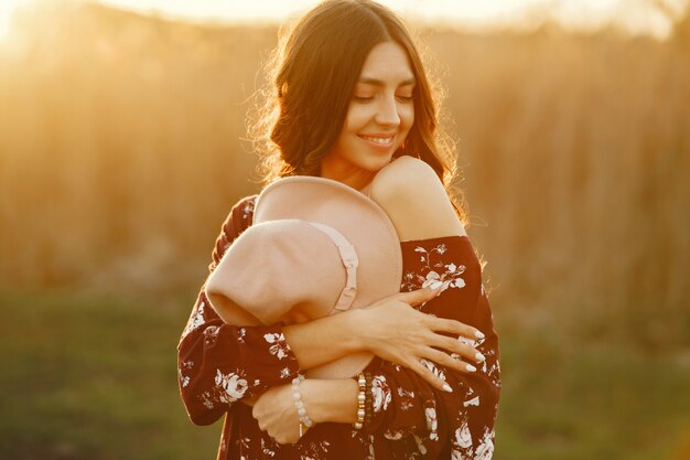 Stylish woman spending time in a summer field