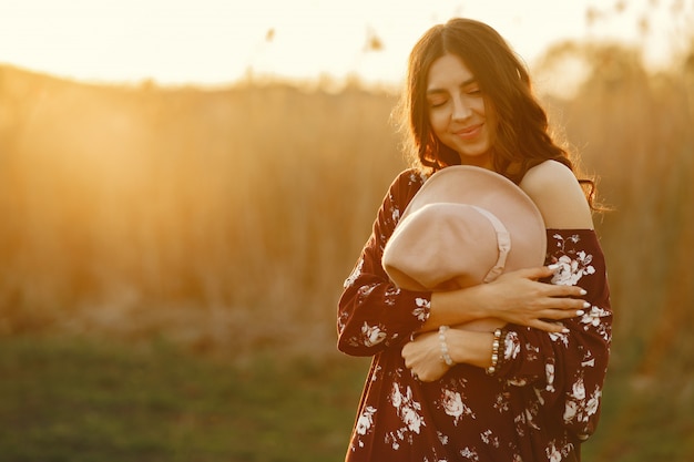 Stylish woman spending time in a summer field