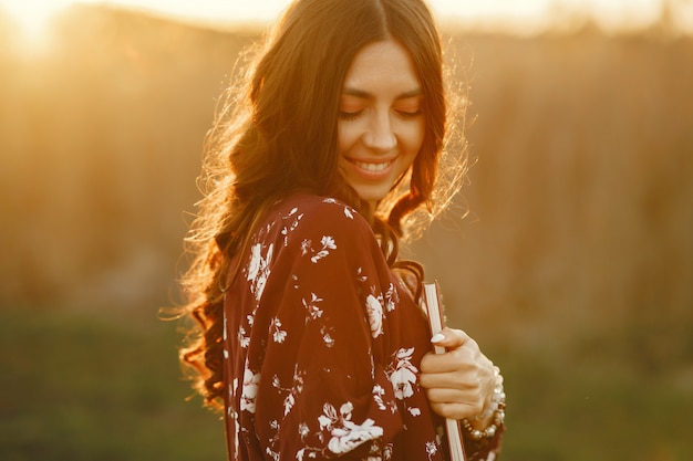 Stylish woman spending time in a summer field