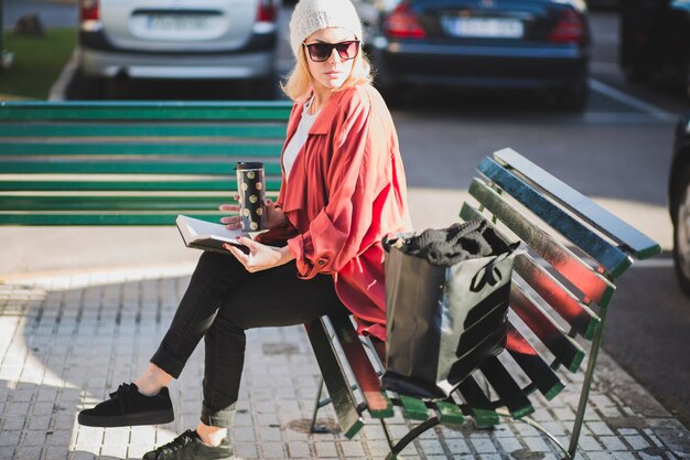 Stylish woman with book and cup