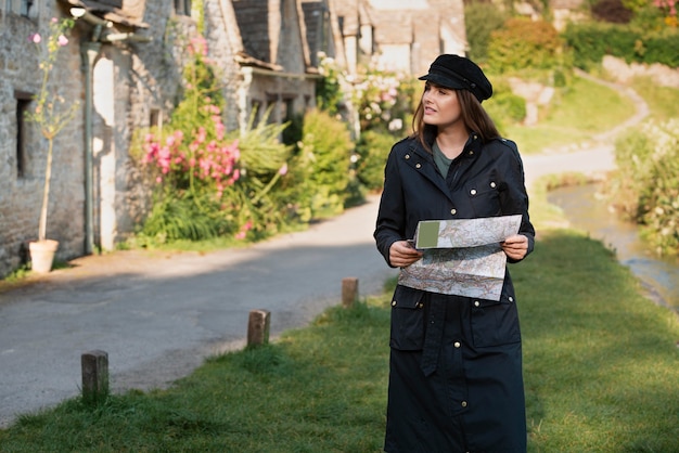 Stylish woman with map for traveling