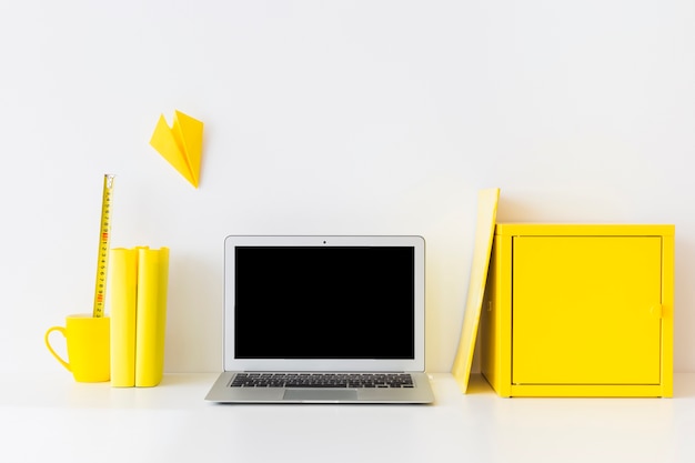 Free Photo stylish workspace with laptop and yellow metal box