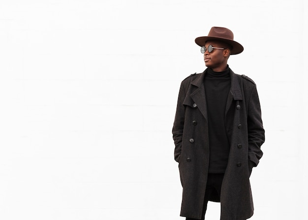 Stylish young man with sunglasses and hat