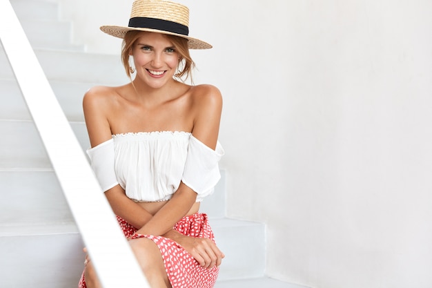 Stylish young woman posing on stairs