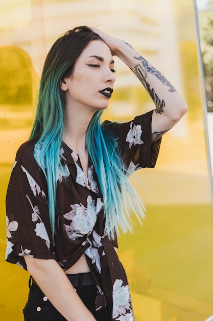 Stylish young woman with tattoo on her hand