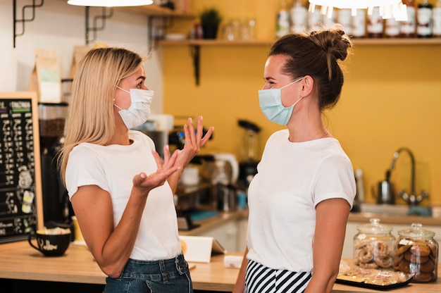 Stylish young women wearing face masks