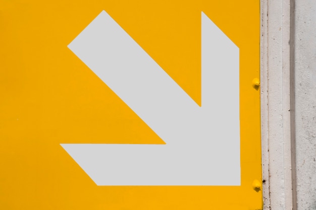 Free photo subway white arrow on yellow background