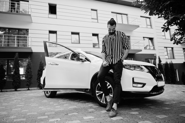 Free Photo successful arab man wear in striped shirt and sunglasses pose near his white suv car stylish arabian men in transport