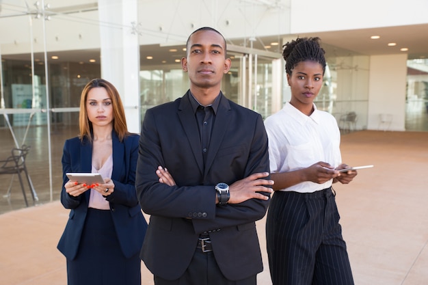 Free photo successful business team posing in office hall